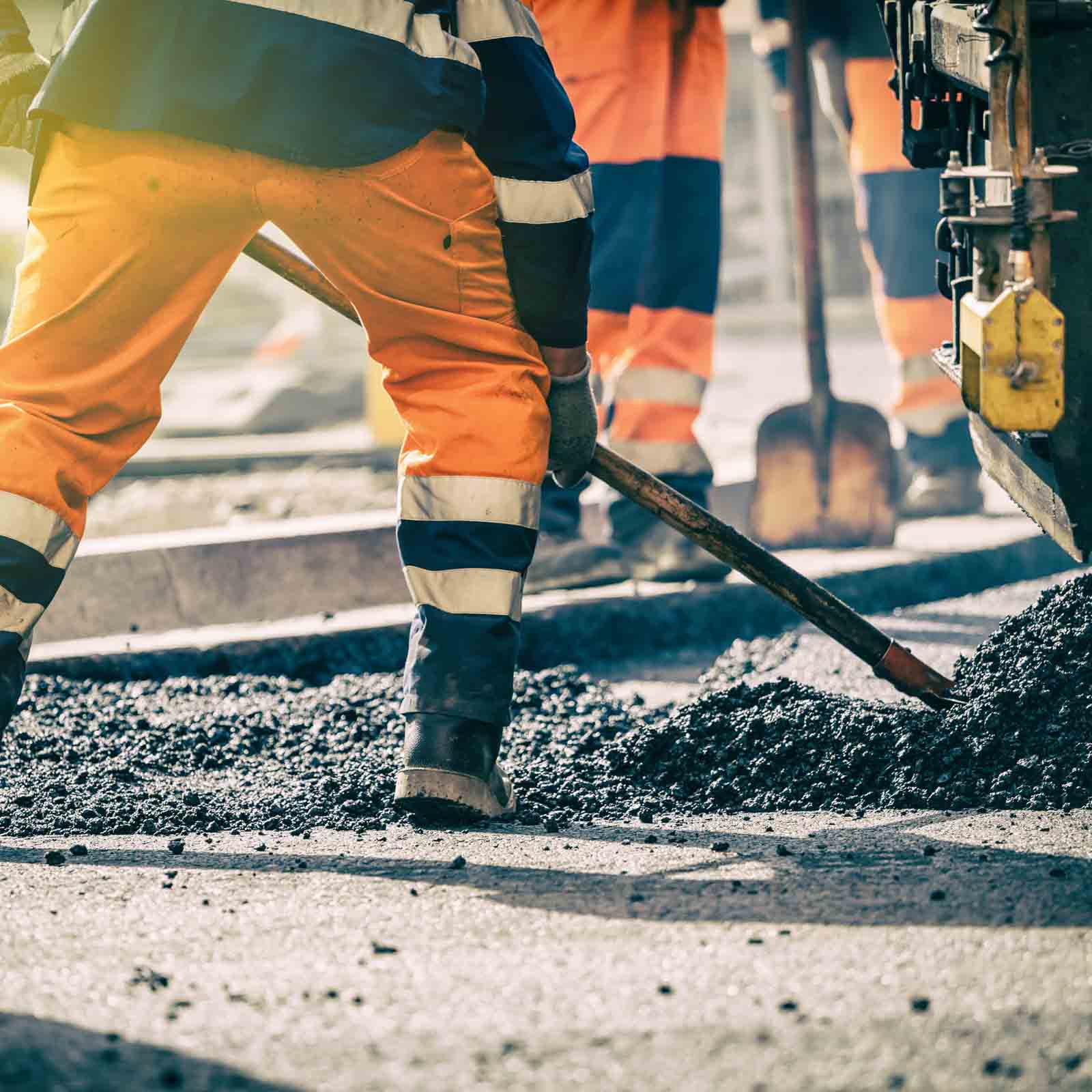 construction-worker-shoveling-asphalt