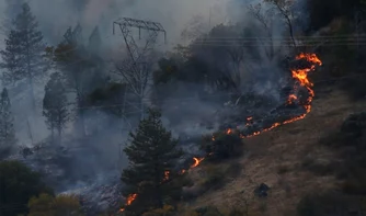 fire on hill caused by power lines